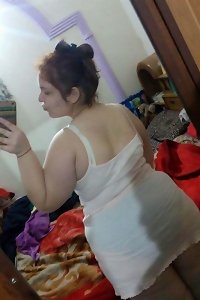 voluptuous plumper female in sensual underwear inspecting her assets with delectation